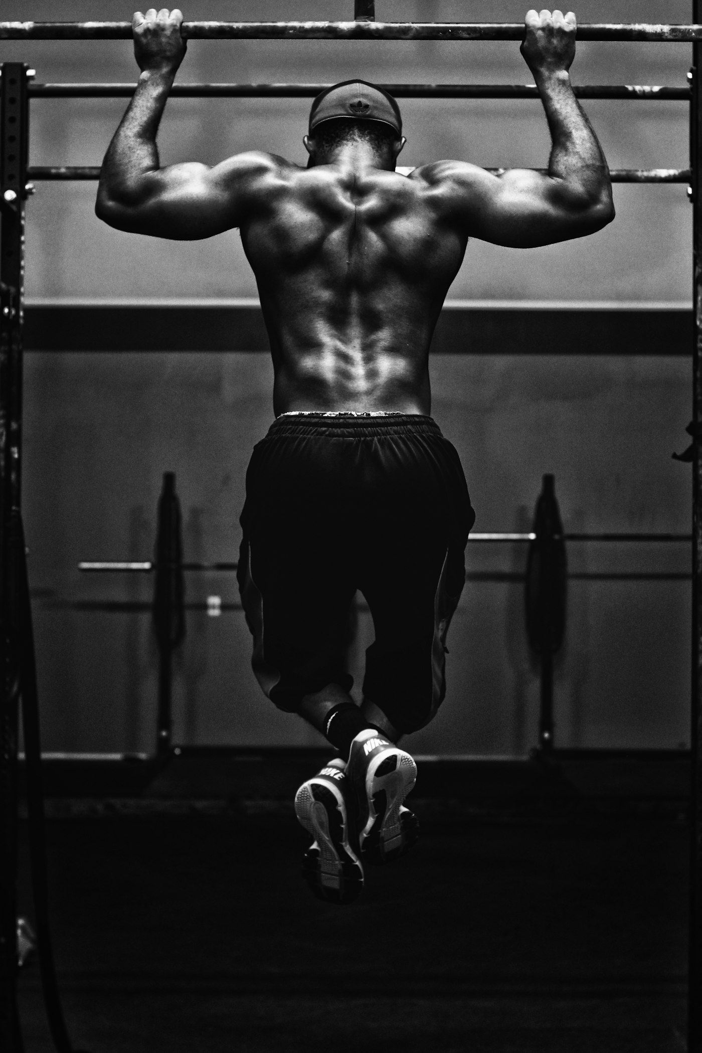 Athlete performing a pull-up, black and white